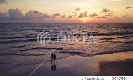 Happy Asian couple dating at the beach during Happy Asian couple dating at the beach during 54079494