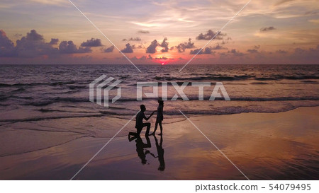 Happy Asian couple dating at the beach during 54079495
