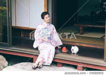 A woman in a yukata that cools on the veranda 54080993