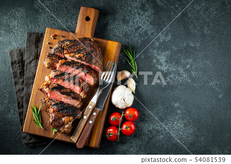 Steak ribeye, grilled with pepper and garlic. 54081539