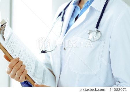 Female doctor using medical form on clipboard closeup. Physicianat work in hospital or clinic 54082071