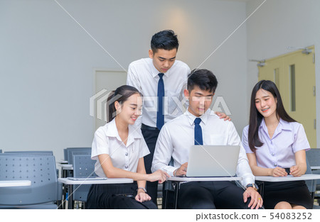 Students in uniform working with laptop 54083252