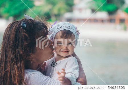 baby in the arms of the mother. Woman holding a baby in the arms of the mother. Woman holding a 54084803