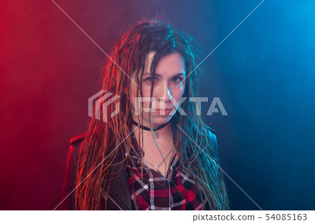 Portrait of young woman with dreadlocks having fun over the dark background 54085163