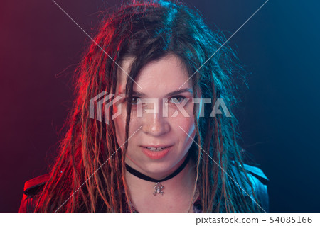 Youth, hairstyle and modern concept - young woman with dreadlocks over the red and blue light 54085166
