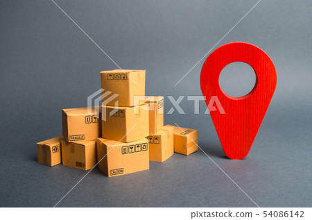 A pile of cardboard boxes and a red position pin 54086142