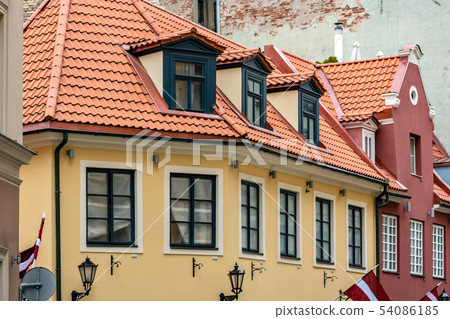 Yellow house with red roof. 54086185