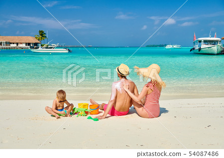 Family with three year old boy on beach Family with three year old boy on beach 54087486