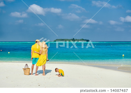 Family with three year old boy on beach Family with three year old boy on beach 54087487