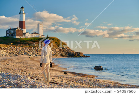 Woman tourist at the beach near Montauk Lighthouse Woman tourist at the beach near Montauk Lighthouse 54087606