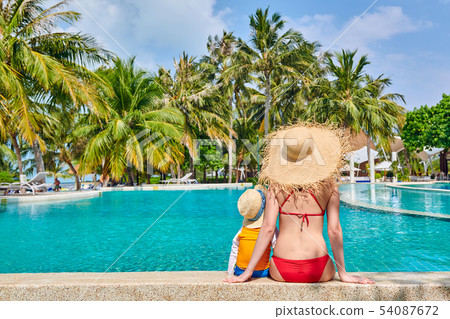 Toddler boy in resort swimming pool with mother Toddler boy in resort swimming pool with mother 54087672