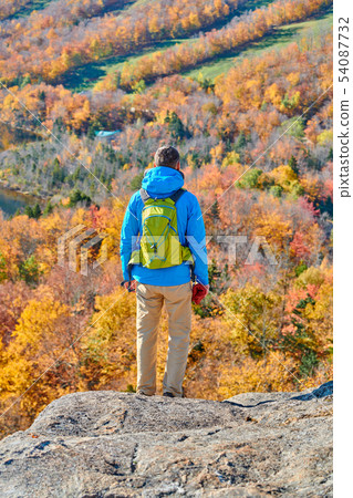 Backpacker man at Artist's Bluff in autumn Backpacker man at Artist's Bluff in autumn 54087732