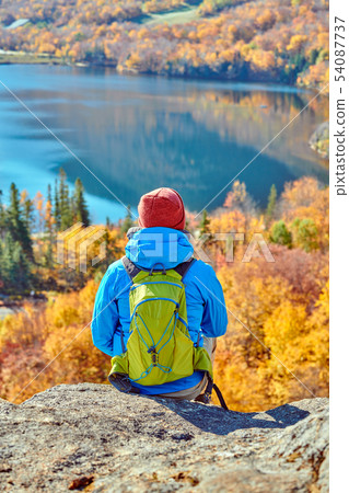 Backpacker man at Artist's Bluff in autumn Backpacker man at Artist's Bluff in autumn 54087737