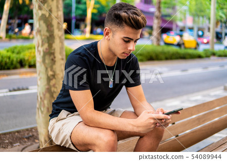 man on the street chatting on a cell phone man on the street chatting on a cell phone 54089944