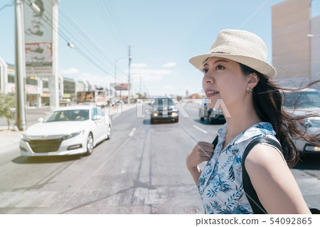 asian woman with backpack crossing road asian woman with backpack crossing road 54092865