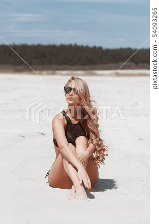 Beautiful young girl in a sexy bikini on the beach Beautiful young girl in a sexy bikini on the beach 54093265