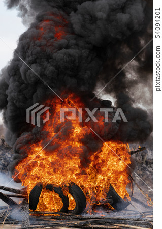 Burning automobile tires, strong flame of red fire Burning automobile tires, strong flame of red fire 54094201