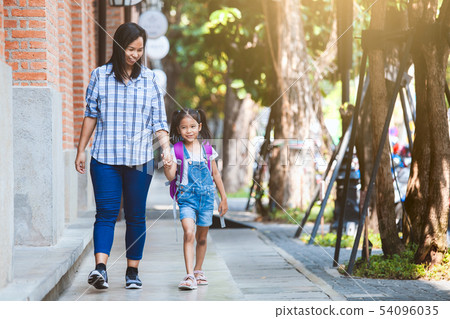 pupil girl hold her mother hand and go to school pupil girl hold her mother hand and go to school 54096035