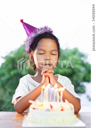 girl make folded hand to wish for her birthday girl make folded hand to wish for her birthday 54098944