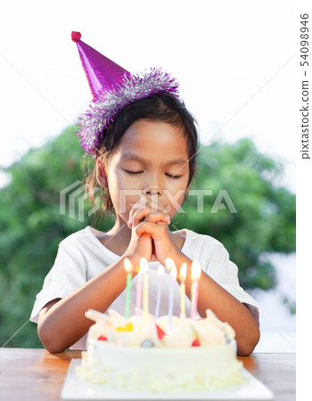 girl make folded hand to wish for her birthday girl make folded hand to wish for her birthday 54098946
