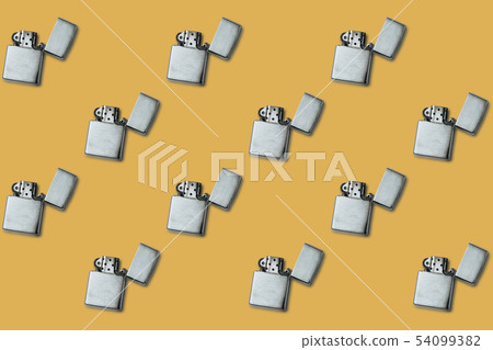 Gasoline lighter, metal lighter on a yellow 54099382