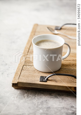A cup of coffee on light grey background 54099872