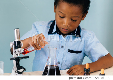 Black boy mixing chemicals in lab Black boy mixing chemicals in lab 54101000
