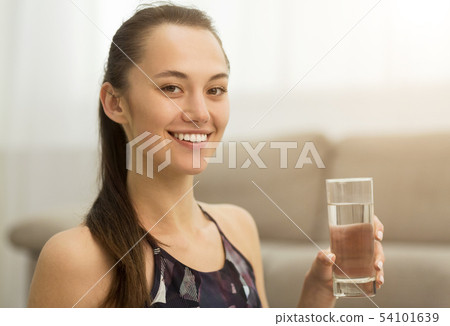 Healthcare. Girl drinking clean mineral water, side view Healthcare. Girl drinking clean mineral water, side view 54101639