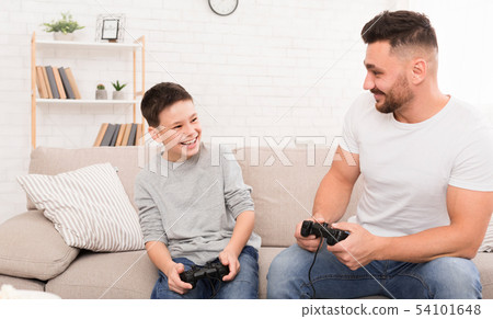 Cheerful father and son playing video game at home 54101648