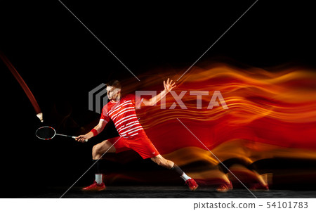 Young man playing badminton isolated on black studio background Young man playing badminton isolated on black studio background 54101783