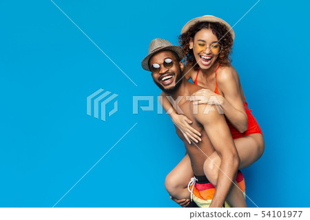 Happy black girl piggybacking with her boyfriend 54101977