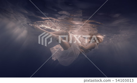 Woman in a white dress under water 54103013