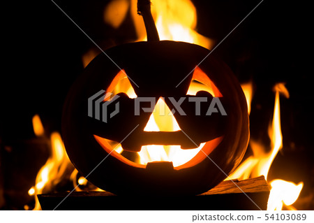Halloween pumpkin with scary face on fire background. 54103089