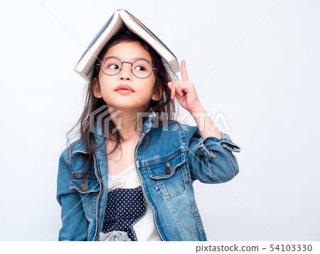 little cute girl wear glasses and book on head little cute girl wear glasses and book on head 54103330