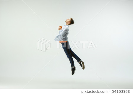 Man working at office and jumping isolated on studio background 54103568