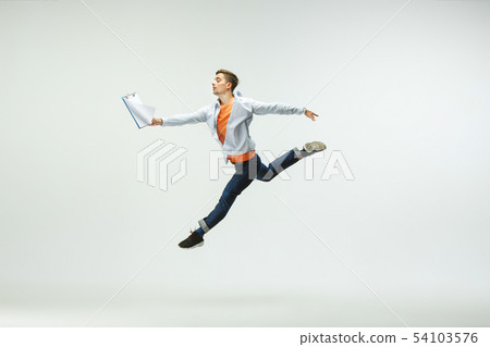 Man working at office and jumping isolated on studio background Man working at office and jumping isolated on studio background 54103576