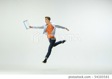 Man working at office and jumping isolated on studio background Man working at office and jumping isolated on studio background 54103581