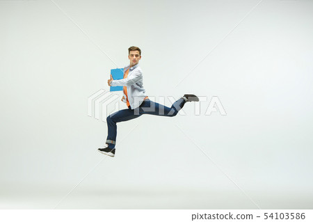 Man working at office and jumping isolated on studio background Man working at office and jumping isolated on studio background 54103586