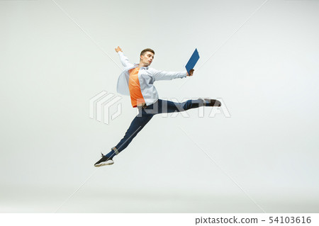 Man working at office and jumping isolated on studio background 54103616