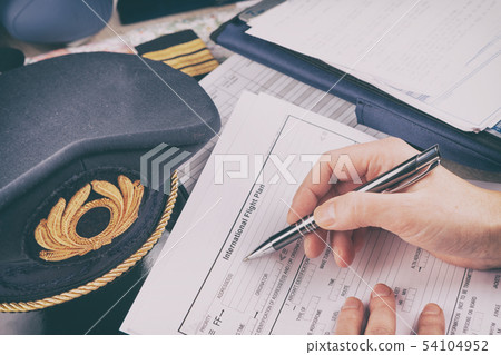 Airplane pilot filling in flight plan 54104952