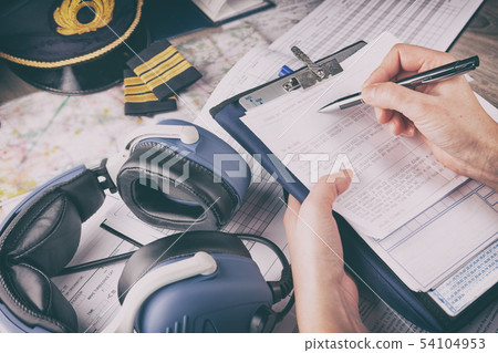Airplane pilot filling in flight plan Airplane pilot filling in flight plan 54104953