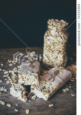 Homemade Granola with Nut Mix In Jar on wooden board on stone table background. Healthy Food Concept 54105004