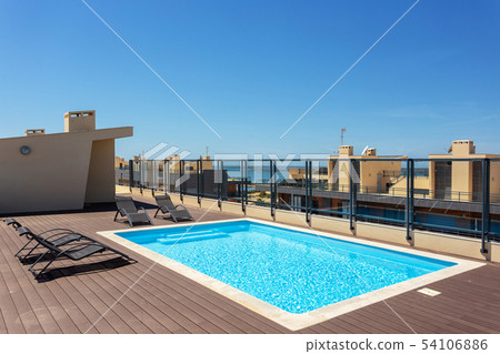 Modern pool for tourists on the roof of the building. Modern pool for tourists on the roof of the building. 54106886