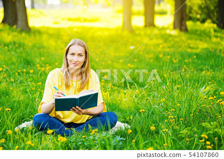 Smiling woman in summer park Smiling woman in summer park 54107860