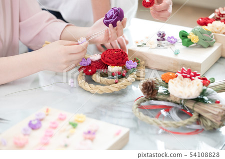 Women making New Year decorations 54108828