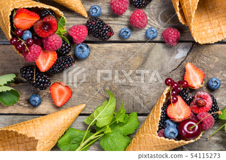 Selection of berries in ice cream cones - healthy dessert concept Selection of berries in ice cream cones - healthy dessert concept 54115273