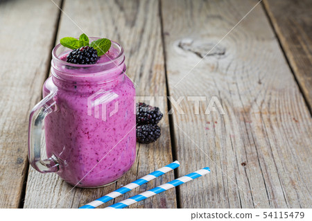 Blackberry jogurt smoothie in glass jar Blackberry jogurt smoothie in glass jar 54115479