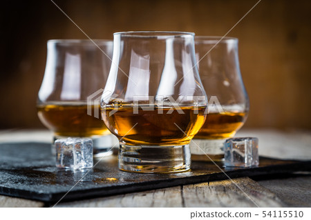 Whiskey with ice in glasses Whiskey with ice in glasses 54115510