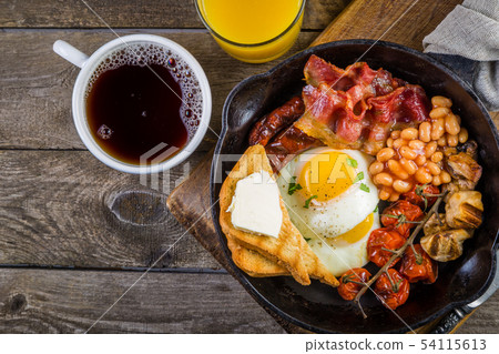 Full english breakfast - eggs, bacon, beans, toast, coffee and juice Full english breakfast - eggs, bacon, beans, toast, coffee and juice 54115613