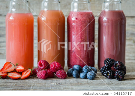 Selection of berry smoothies on rustic wood background Selection of berry smoothies on rustic wood background 54115717